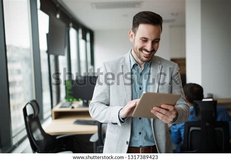 Young Businessman Using Digital Tablet Office Foto Stock 1317389423