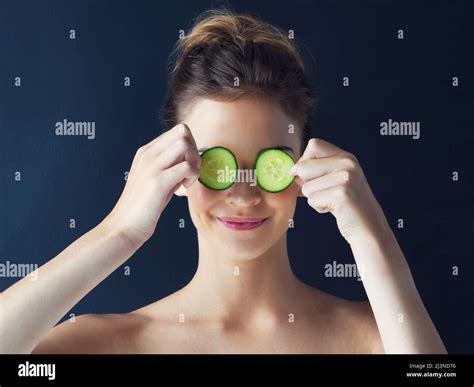 Nature Inspires Soft Pampered Skin Cropped Shot Of A Beautiful Young Woman Holding Cucumbers