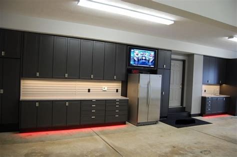 You can buy new cabinets or thrift them and fill the wall with hidden storage. black garage cabinets ikea garage wall cabinets | Garage ...