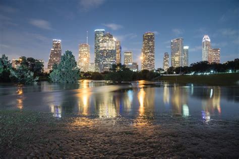 Reflection Of Downtown Houston Skyscrapers On A Pond Of Overflow Water