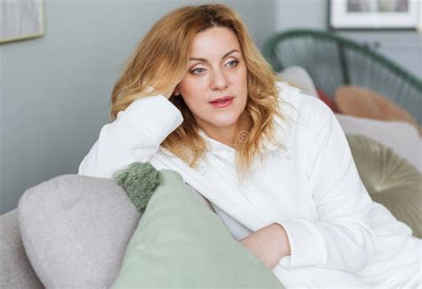 Calm Woman With Closed Eyes Resting On Cozy Couch Enjoying Lazy