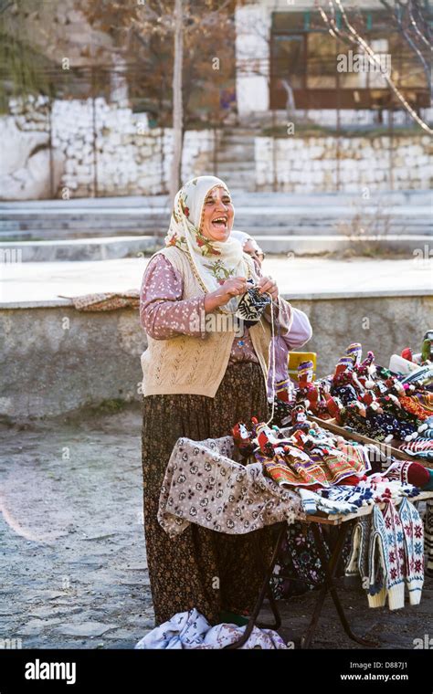 Laughing Jolly Turkish Woman Knitting And Selling Knitted Goods And