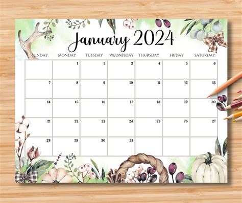 A Calendar With Watercolor Flowers And Leaves Is Shown On A Wooden