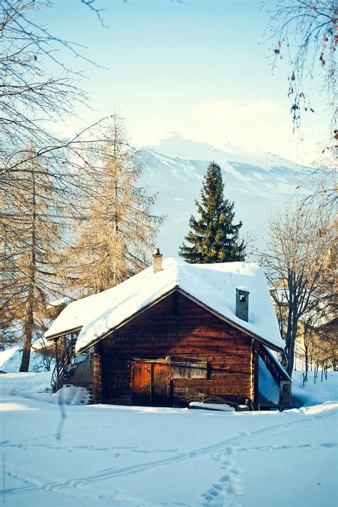 Wooden Cabin In The Snow In The Mountains Del Colaborador De Stocksy