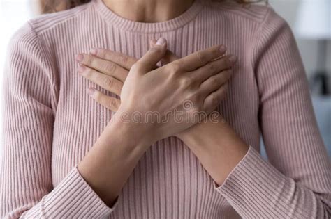 Close Up Of Woman Keep Hands At Chest Show Gratitude Stock Photo