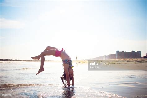 Girl Doing Handstands At The Beach High Res Stock Photo Getty Images