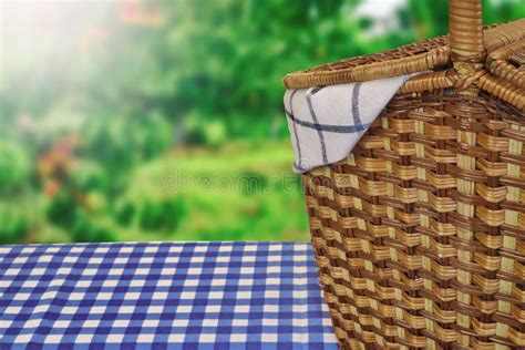 Picnic Basket On The Table With Blue Checkered Tablecloth Stock Photo