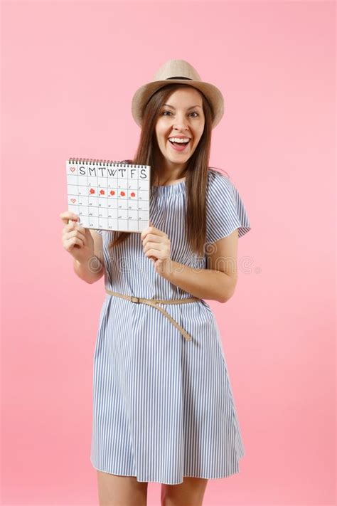 Portrait Of Happy Woman In Blue Dress Hat Holding Periods Calendar For