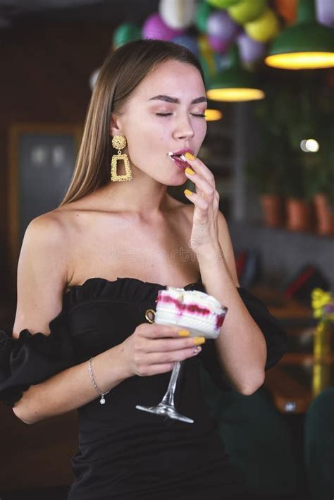 beautiful brunette woman in restaurant or cafe with ice cream tiramisu dessert fashion photo of
