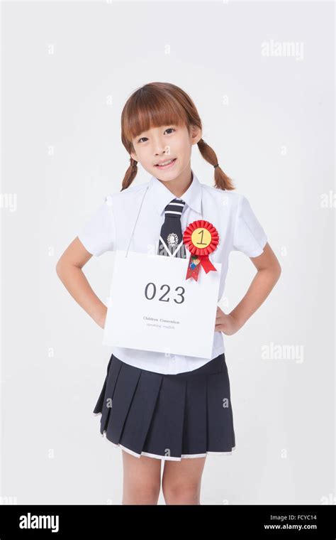 Elementary School Girl In School Uniform With A Numbering Tag And