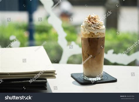 When you taste stok, you taste coffee. Iced coffe with whipcream on the table near the window #Ad ...