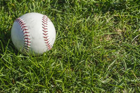 White Ball For Playing Baseball On The Grass Background Stock Image
