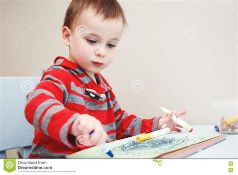 Boy Toddler Drawing With Color Pencils Markers On Paper In Album Stock