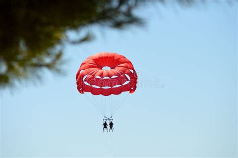 Red Parachute Carries Two People Stock Image Image Of Petal