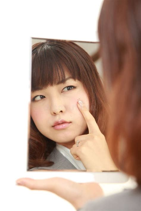 Young Japanese Businesswoman Worries About Dry Rough Skin Stock Image