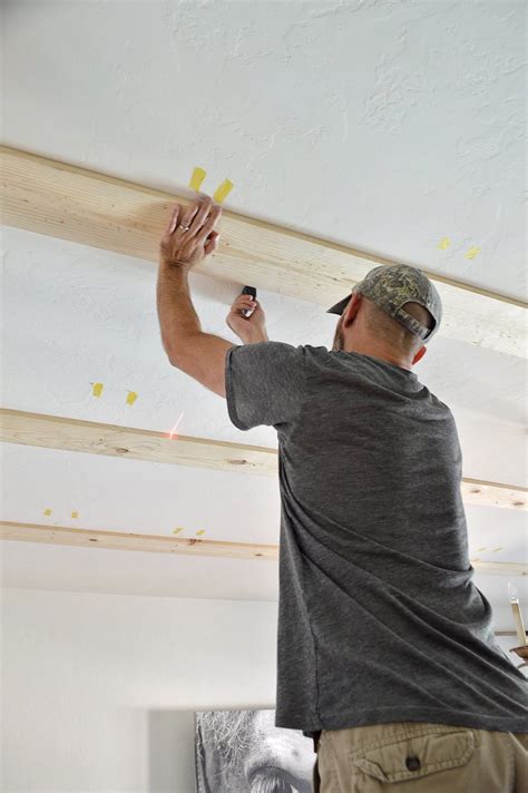 These new ceiling barn beams look like reclaimed barn beams. DIY Faux Wood Beams | Faux wood beams, Faux wood wall ...