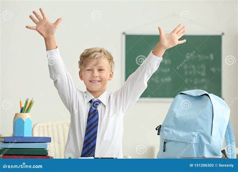 Happy Little Schoolboy After Finishing His Homework In Classroom Stock
