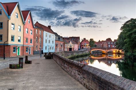 The Pastel And Red Brick Townhouses Overlooking The River Yare At