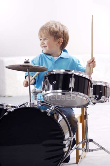 Smiling Little Boy Playing Drums — Blond Light Background Stock