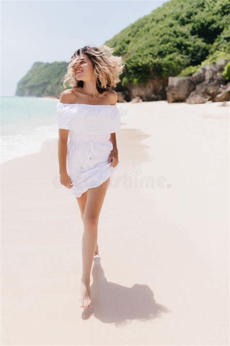 Full Length Portrait Of Romantic Blonde Girl Walking Down The Beach With Smile Blissful Fair