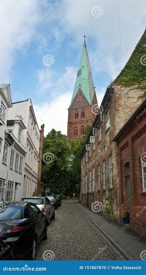 View Of Street With Old Houses And Church In The Centre Of City