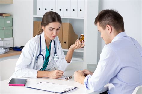 Female Medicine Doctor Prescribing Pills To Her Male Patient Healthcare