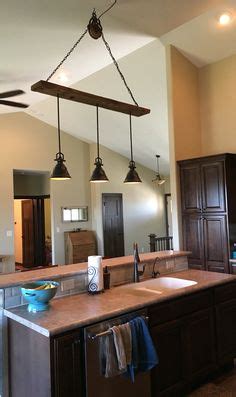 Pendant lights with a long drop or that have a clustered shade style to them look amazing suspended from a vaulted ceiling. Barn wood pulley vaulted ceiling light fixture Pendants ...