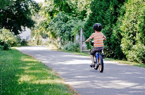 Boy Riding His Bike By Stocksy Contributor Cara Dolan Stocksy