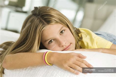 Teenage Girl Lying On Bed And Looking At Camera — Female Caucasian