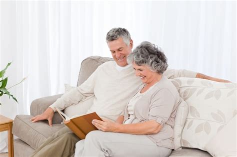 premium photo senior couple looking at their photo album