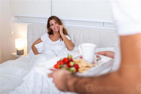 Care and romance at the morning. Surprised and happy young woman lying