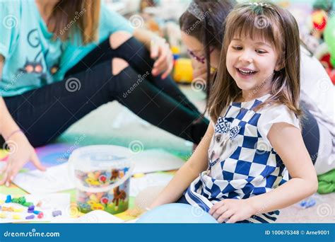 Cheerful Pre School Girl Wearing A Trendy T Shirt While Playing Stock