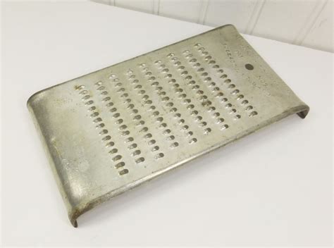 A Grater Sitting On Top Of A White Table