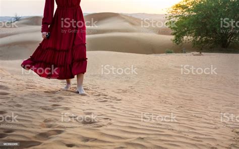 Woman Walking In The Desert At Sunset Stock Photo Download Image Now