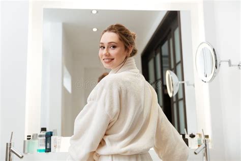 Happy Beautiful Young Woman Standing Near The Mirror In Bathroom Stock Image Image Of Bathrobe