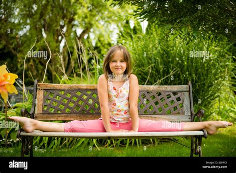 Child Little Girl Performing Gymnastic Pose On Bench
