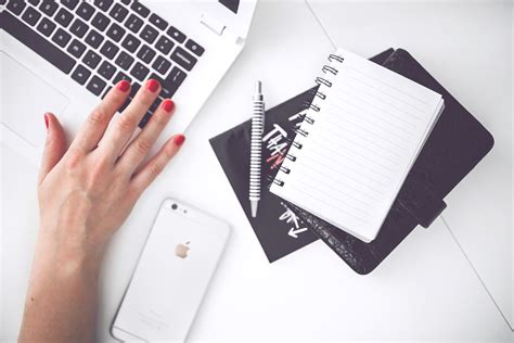 White Laptop Female Hand Note Pen Phone Desk · Free Stock Photo