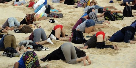 Australians Stick Their Heads In The Sand To Mock Prime Minister Abbott