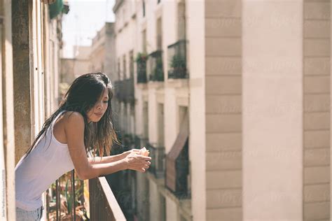 Asian Woman Eating Breakfast On The Balcony In Barcelona By Stocksy