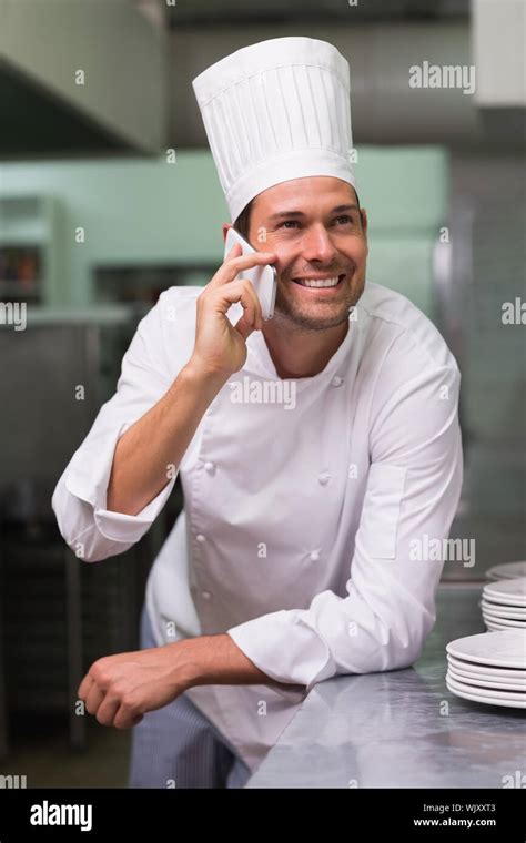 Happy Chef Talking On The Phone In A Commercial Kitchen Stock Photo Alamy