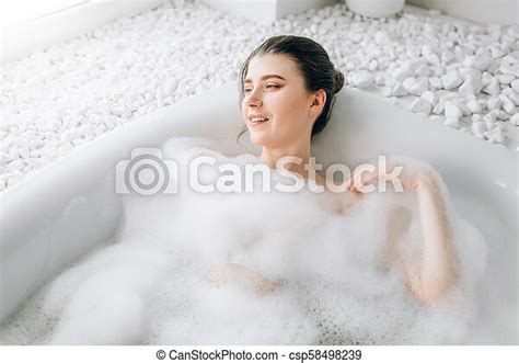 Attractive Lady Lying In Bath With Foam Top View Relaxation Health And Skin Care In Bathroom