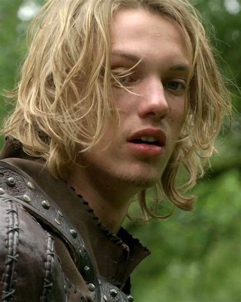 A Man With Long Blonde Hair Wearing A Leather Jacket