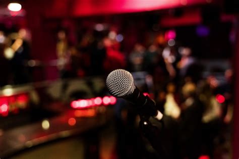Premium Photo Microphone On A Stand Up Comedy Stage With Colorful Bokeh
