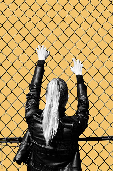 woman looking through the fence by stocksy contributor evgeniy shvets stocksy