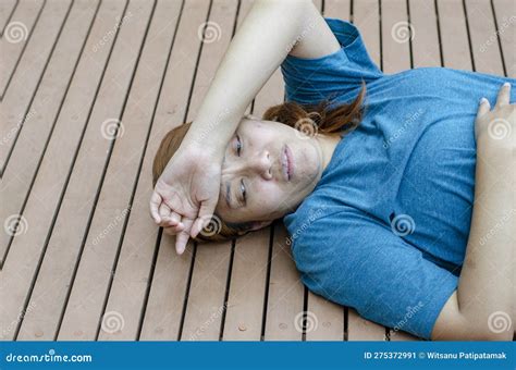 asian woman fainting putting her hands on her forehead because of hot weather stock image