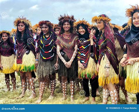 Young Girls Of A Papuan Tribe In A Beautiful Crown From Bird Feathers