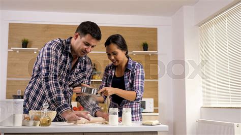 wife helping her husband in the kitchen stock image colourbox