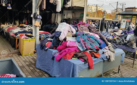 Buyers And Piles Of Clothing In The Flea Market Editorial Stock Image