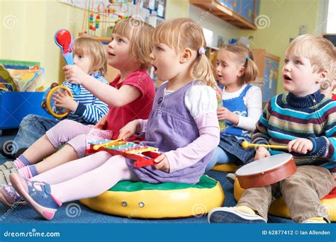 Group Of Pre School Children Taking Part In Music Lesson Stock Photo