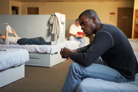 Men Sitting On Beds In Homeless Shelter Stock Image Image Of American
